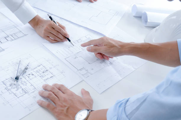 istock Colleagues interior designer Corporate Achievement Planning Design on blueprint Teamwork Concept with compasse. 1487285666
