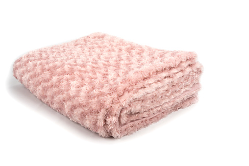 Pink folded blanket on a white background