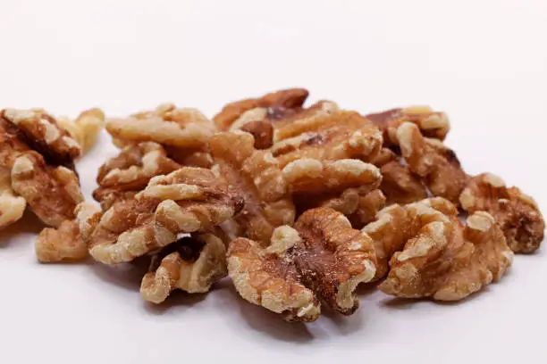 a pile of walnuts on a white background