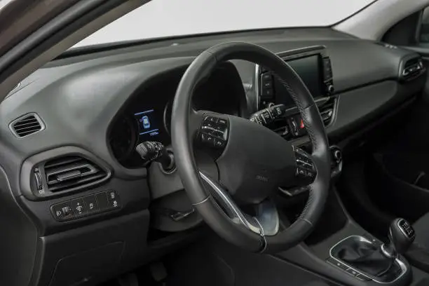 Car interior with a steering wheel, control buttons and manual shift