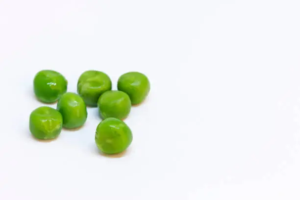 several green peas on a white background