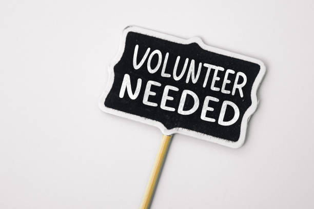 istock VOLUNTEER NEEDED - text on a small chalkboard on a neutral background. Top view. Life and business motivational inspirational concept 1487287026