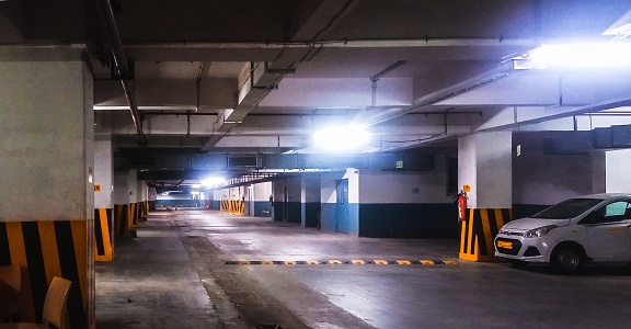 Empty parking garage with one car