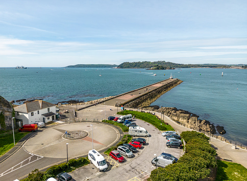 Plymouth, UK. 2 April 2023. Car park and people walking on the footpath along Mount Batten Break Water in Plymouth.