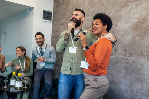 istock Business people singing karaoke in modern office 1487290041