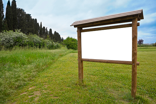 Blank wooden advertising signboard in a public park - concept with copy space for text inserting