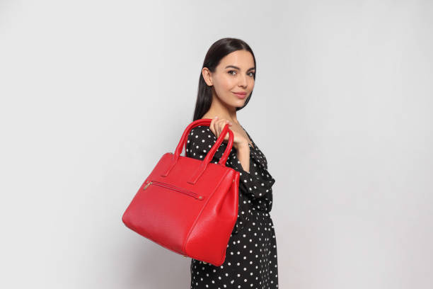 istock Young woman with stylish bag on white background, 1487290373