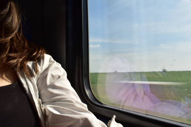 istock Woman daydreaming on a train trip 1487290440