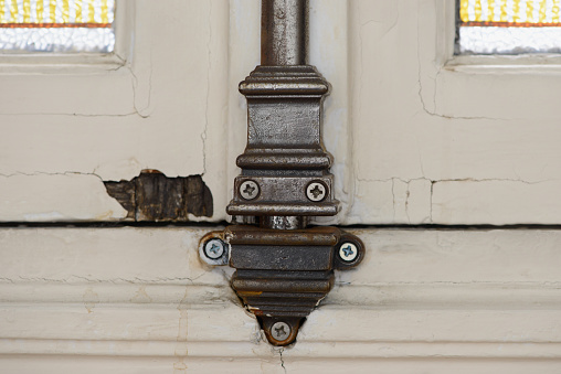 Cast iron window hardware detail in Haussmannien building in Paris, France.