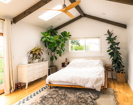 A large bed in the modern bedroom of a house in Los Angeles, decorated to a Scandinavian style.