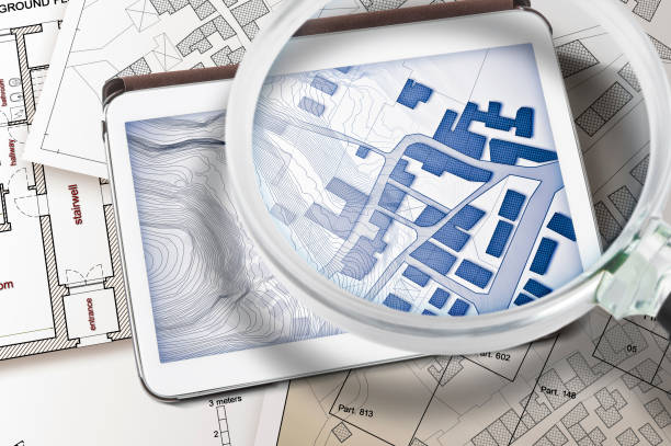 istock Imaginary cadastral map of territory with buildings and land parcel - concept with a digital tablet 1487292338
