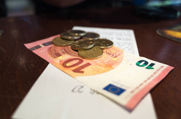 Paying Cafe Bill in Euros - Coins and Notes on Paper Bill stock photo