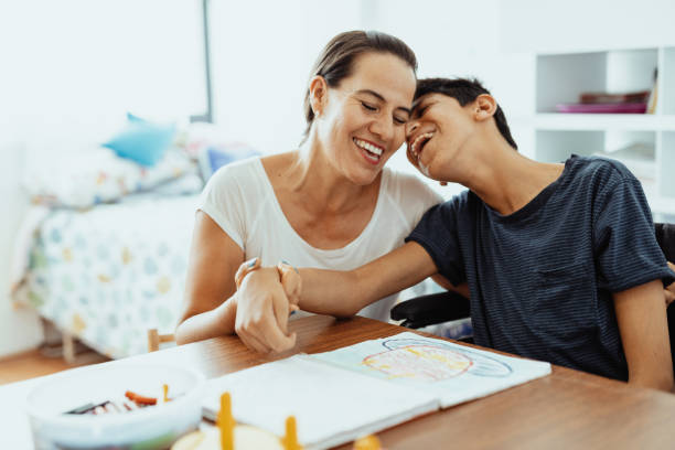 istock Children with disabilities learning better with parents. Woman and boy learning together 1487293804
