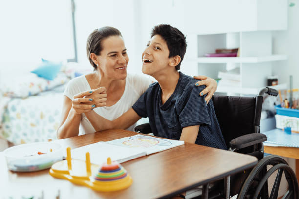 istock Children with disabilities learning better with parents. Woman and boy learning together 1487293958