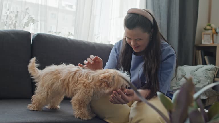 Girl With Disability Petting Her Dog