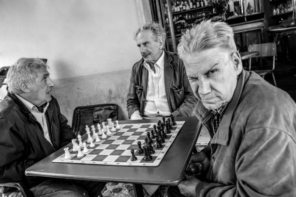 成人男性は、ローマの歴史的中心部でのチェスゲーム中に愚かな顔をします - chess mate ストックフォトと画像
