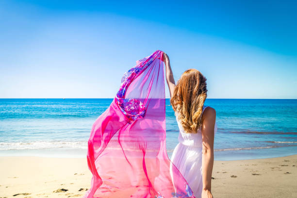 istock Girl jumping on the beach 1487298679