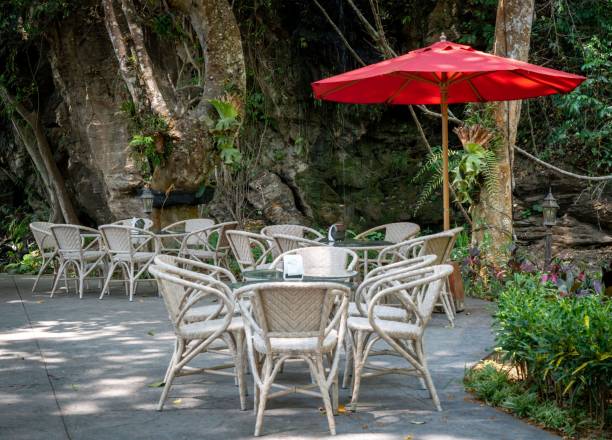 istock the tables and chairs outside under a red umbrella are in front of trees 1487299511
