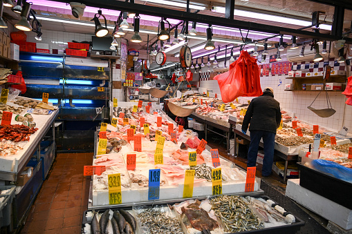 Tokyo, Japan - December 8, 2015: A Japanese man selling fresh king crab, fish & more seafood at Tsukiji Fish Market