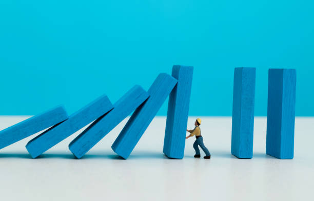 istock People figurine stopping the dominos falling 1487303943
