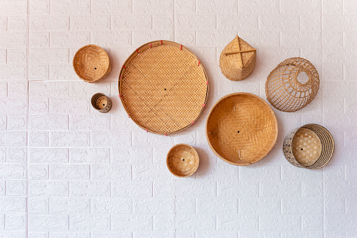 Group of bamboo wicker model (fishing traps) on wall. Decoration interior home concept.