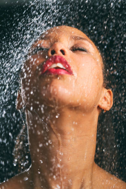 istock African american woman under shower 1487304655