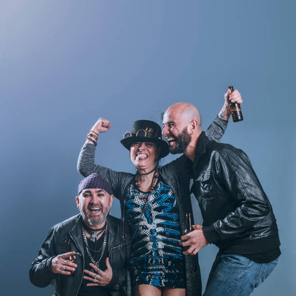 istock alternative friends with beer in hand laugh with joyful expression in studio shot 1487304790