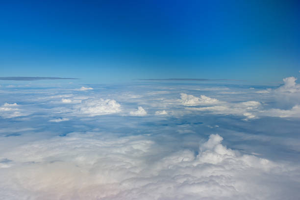 istock Clouds against blue sky view through an airplane window for a background. 1487304877