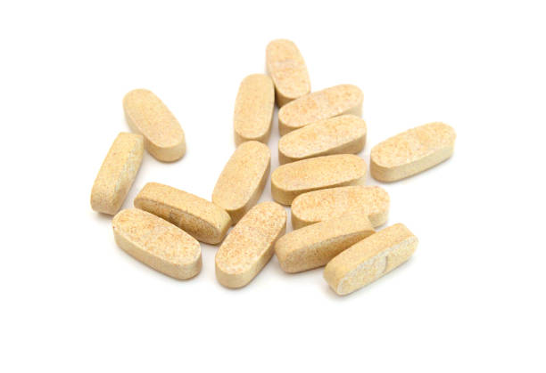 istock Green pills, medicine isolated on white background, top view 1487304998