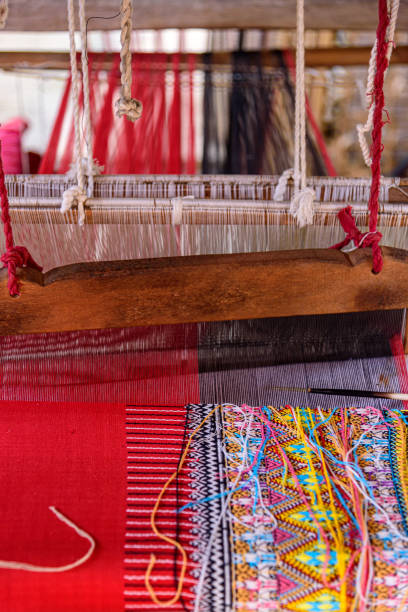 Traditional woven fabric Mae Chaem pattern that has not finished weaving in the loom at Mae Chaem District, Chiang Mai Province, Thailand stock photo