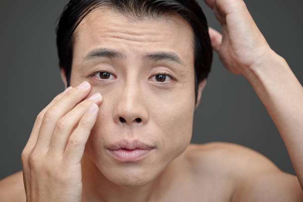 istock Man Applying Skincare 1487308394