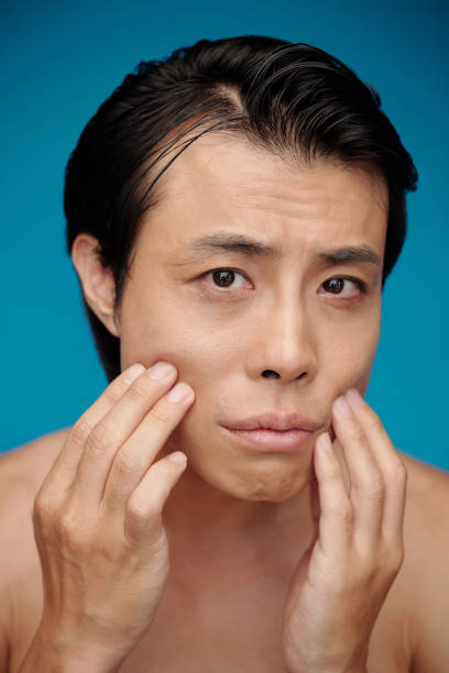 istock Man Noticing Skin Imperfections 1487308498