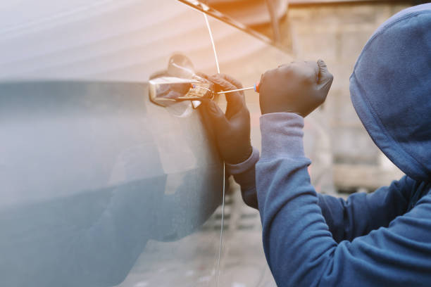 close up car thief hand holding screwdriver tamper yank and glove black stealing automobile trying door handle to see if vehicle is unlocked  trying to break into inside. - tamper imagens e fotografias de stock