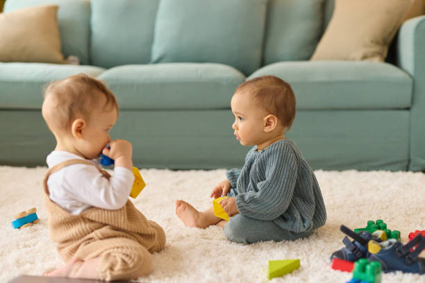 istock Two baby boys playing with toy blocks at home 1487309954