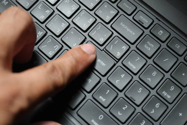 business man's finger operate key board, pushing key Enter on keyboard, Finger with a computer keyboard.