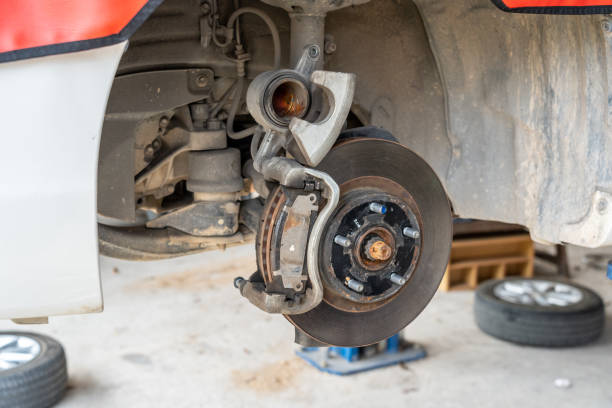 istock Car front disc break being checked and inspected for safety 1487311359
