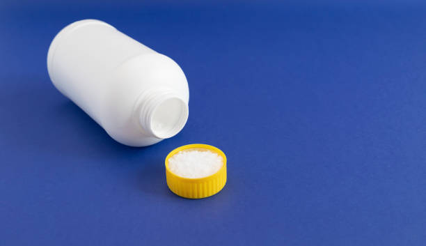 istock Plumber drain granules in Yellow Cap, White Plastic Bottle On Blue Purple Background, Copy Space. Super drain cleaner, Housework Help. 1487311606