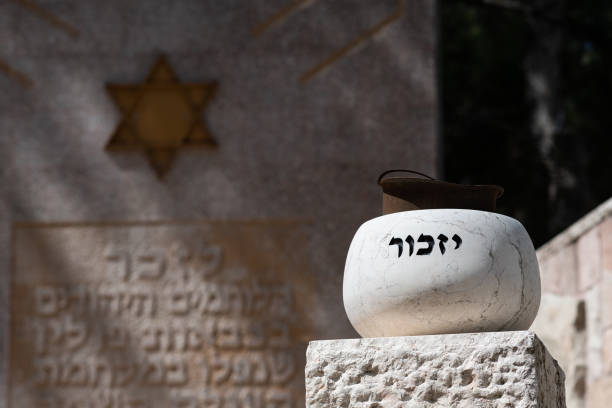 Monument in the Mount Herzl military cemetery in remembrance of Israel's soldiers who died in Poland during World War Two.  Hebrew text in black reads remember and in white remember the Jewish fighters in Poland who fell in battle during World War 2.