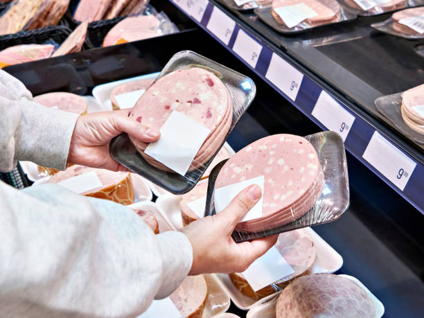istock Woman chooses boiled sausage at store 1487313683