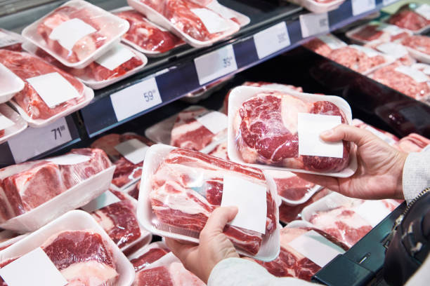 istock Hand with beef meat in shop 1487313732