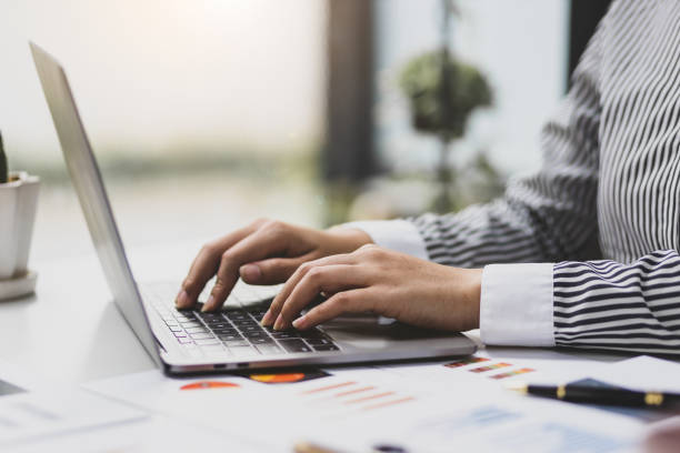 istock Female accountant working with laptop and typing. 1487315968