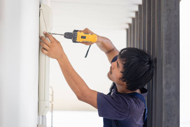 istock Electrician using a screwdriver, Technician installing air conditioning in a client house, Repairman fixing air conditioner unit, Maintenance and repairing concepts 1487317982