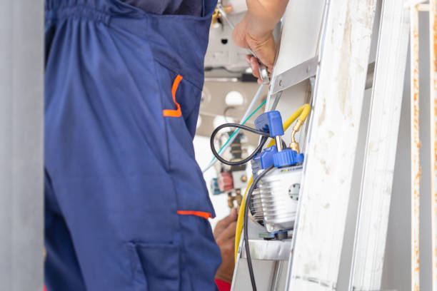 istock Technician man installing an air conditioning in a client house, Young repairman fixing air conditioner unit, Maintenance and repairing concepts 1487318017