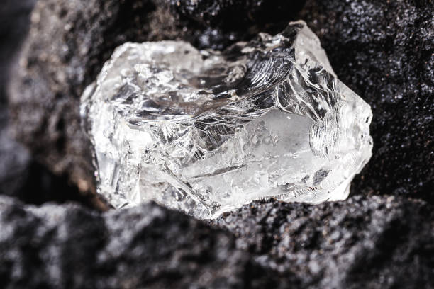 Rough diamond, precious stone in mines. Concept of mining and extraction of rare ores , macro photography stock photo