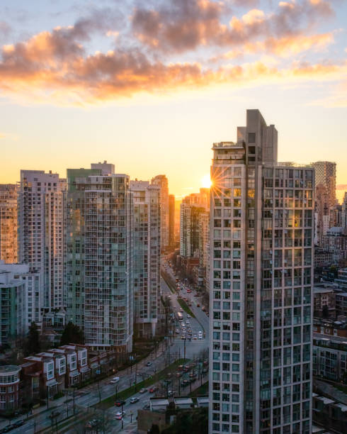 istock Sunset over a city skyline with a road winding between buildings. Pacific Blvd and False Creek in Vancouver 1487319337