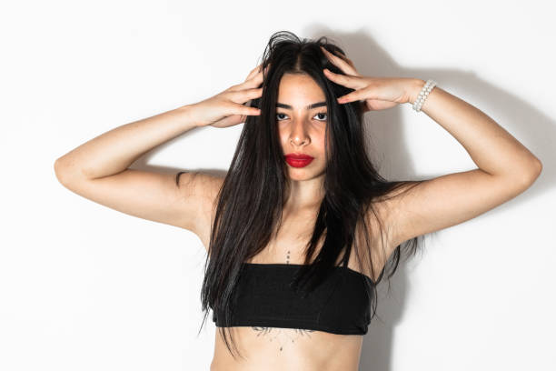 istock beautiful brown skinned latina woman posing frontally with both hands on her head 1487319787