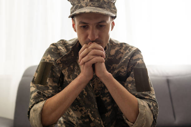 istock Soldier sitting and talking to his therapist 1487320054