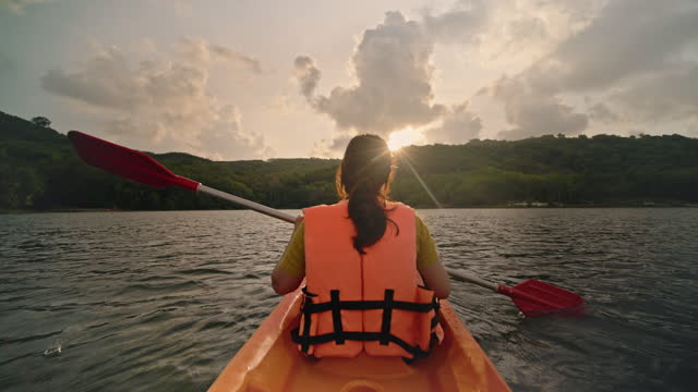 Woman paddling on a kayak enjoying the view