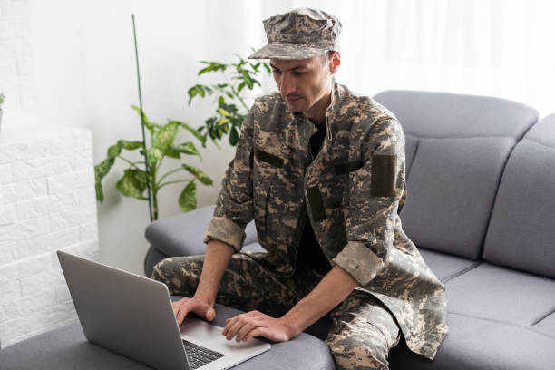 istock partial view of army soldier using laptop on couch 1487320998