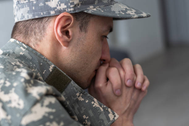 istock Soldier sitting and talking to his therapist 1487321454